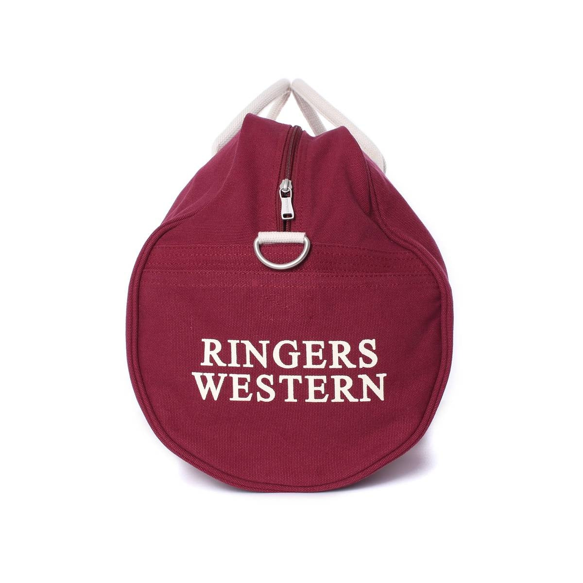 A red Ringers Western Gundagai Duffle bag made from durable cotton canvas, featuring a white zipper and handle. The bag proudly displays "RINGERS WESTERN" in bold white capital letters on the front. Its round shape and sturdy design make it ideal for any adventure.