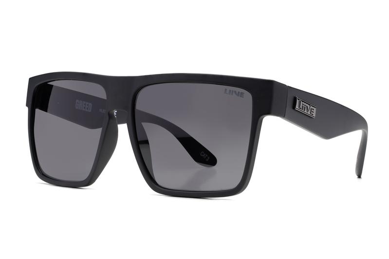 A pair of black, square-framed Liive Greed Sunglasses with dark, polarized grey lenses is displayed against a white background. The brand name "LINE" is visible on the temples, and the word "GREED" is etched subtly on one of the lenses. The lenses offer excellent UV protection.