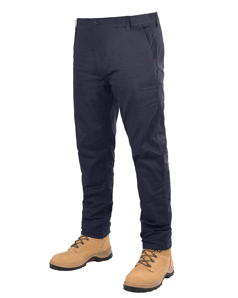 The image displays the UNIT Ignition Stretch Pant in navy blue, featuring multiple pockets and a durable, stretch fabric for enhanced comfort. The pants are paired with rugged tan-colored work boots with brown laces, all set against a plain white background.