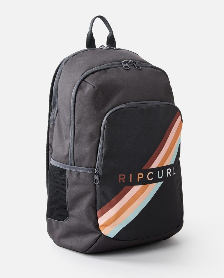 The Rip Curl Ozone 30L Multi Backpack in grey and black features a front compartment adorned with a vibrant stripe pattern in orange, beige, and light blue. Prominently displayed on the front pocket is the Rip Curl logo. The backpack offers a top handle, adjustable shoulder straps, and includes a laptop section for added convenience.