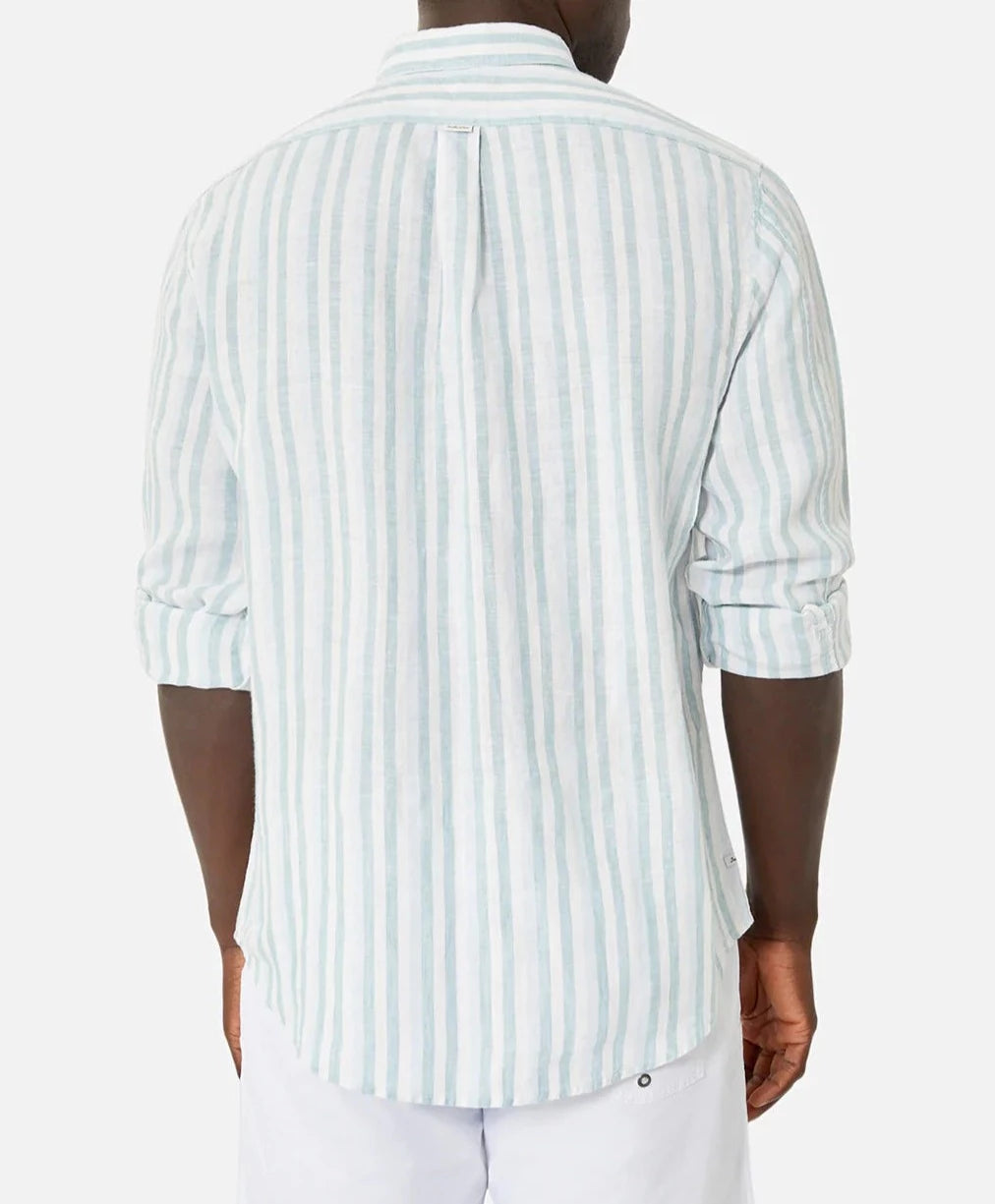 Rear view of someone wearing Industrie The Linenman Shirt, a relaxed fit, light blue and white striped long-sleeve button-up. The sleeves are rolled up for a laid-back look paired with white shorts.