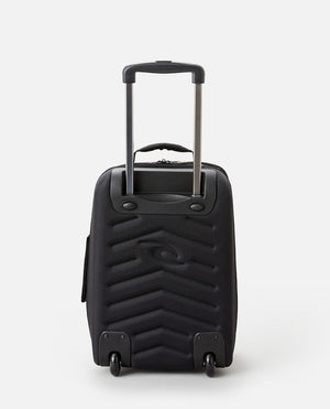 The Rip Curl Paradise F-Light Cabin Bag, with inline skate wheels and a retractable handle, boasts a chevron pattern on its back. This stylish black travel bag stands upright against a white background, ready for any adventure.