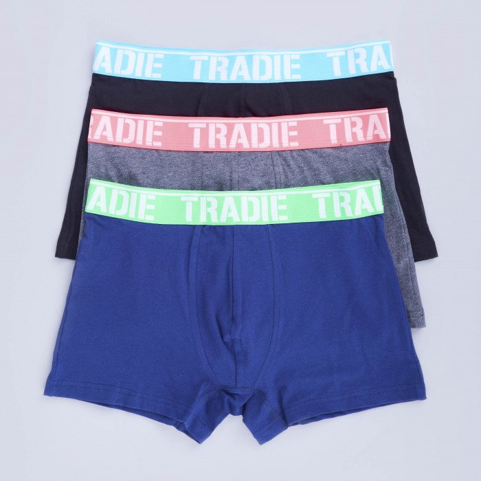 A neatly arranged stack of Tradie Mens 3PK Trunk ensures a comfortable fit. Featuring "TRADIE" on the waistband, these men's boxer briefs come in black with a turquoise waistband, coral with a pink waistband, gray with a gray waistband, and navy with a green waistband. Made from a Cotton/Elastane blend for added comfort.