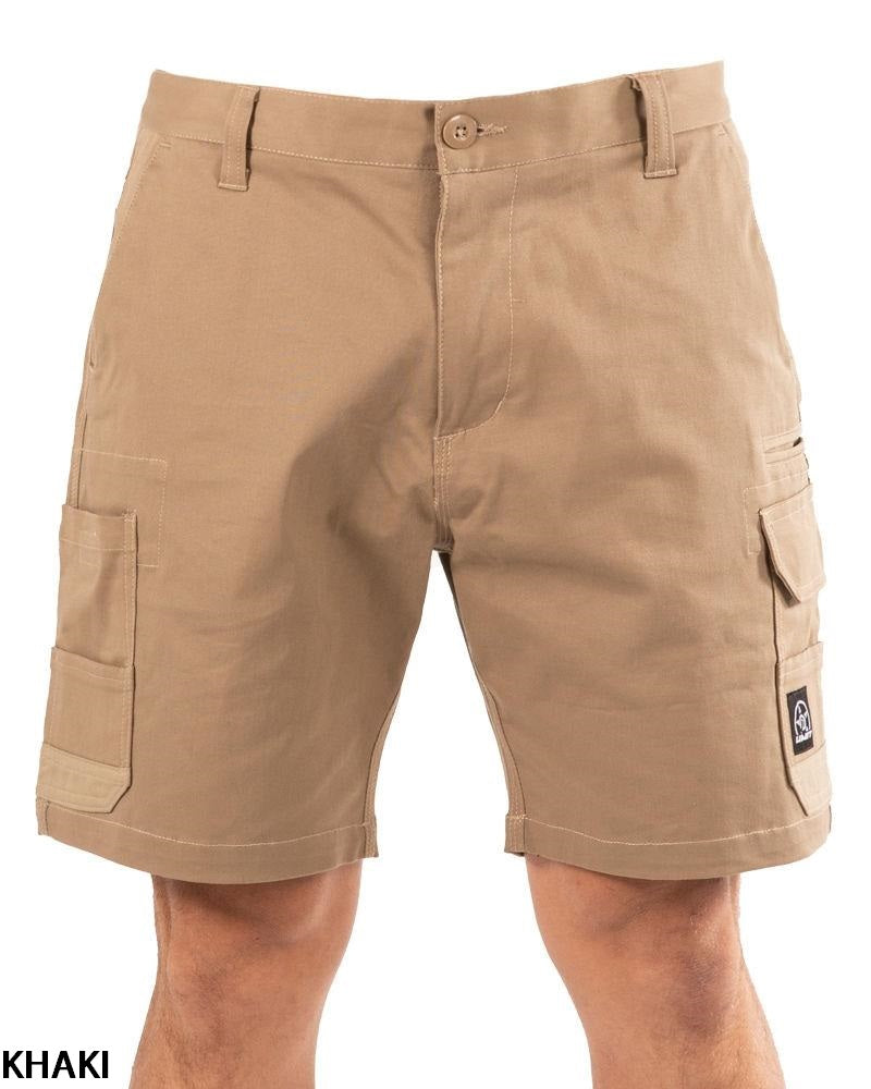A person wearing UNIT Demolition Stretch Cargo Shorts, featuring durable stretch fabric, multiple cargo pockets, belt loops, and a logo patch on the right pocket. Only the lower torso and upper legs are visible against a plain background.