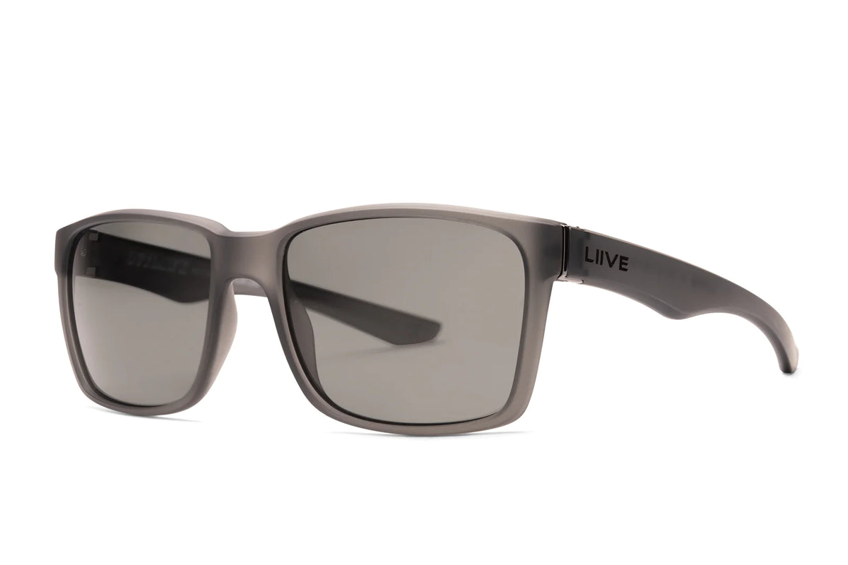 A pair of Outlaw X Polar Sunglasses by Liive with matte black, rectangular impact-resistant lenses and a lightweight, thick solid frame featuring the "LIIVE" logo on the temple. The dark lenses offer a sleek, modern look.