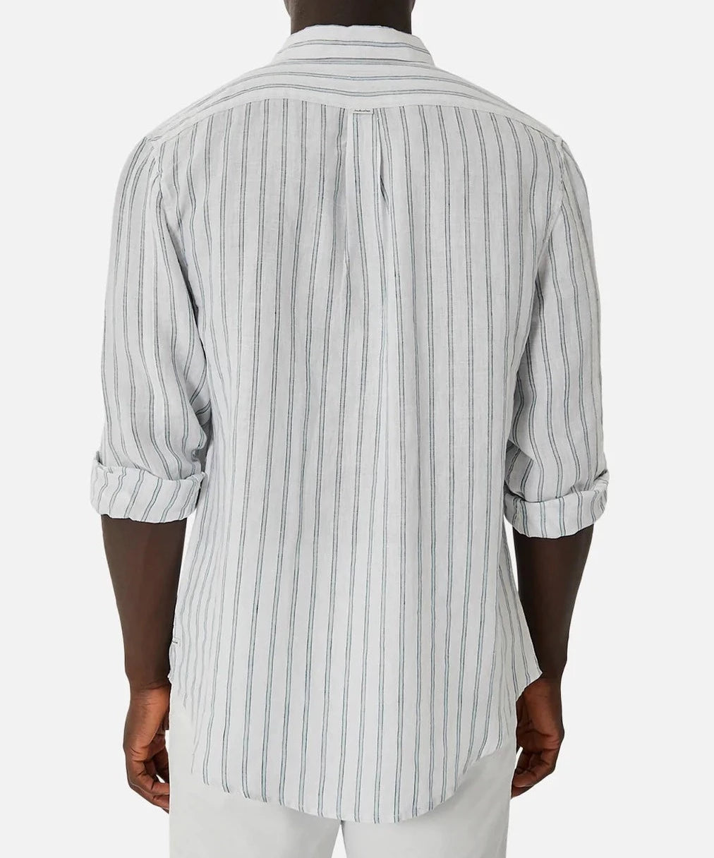 A person is shown from the back, wearing the Industrie The Paglia Long Sleeve Shirt in light gray with dark stripes. The shirt's sleeves are rolled up and is worn over white pants against a simple, light background.