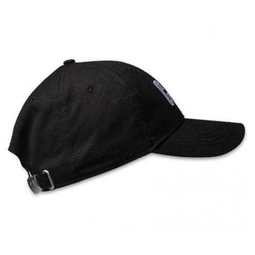 A back view of the black CAT Trademark Cap is displayed against a white background. The cap includes an adjustable strap with a metal buckle and two ventilation eyelets. The brim has a slight curve.