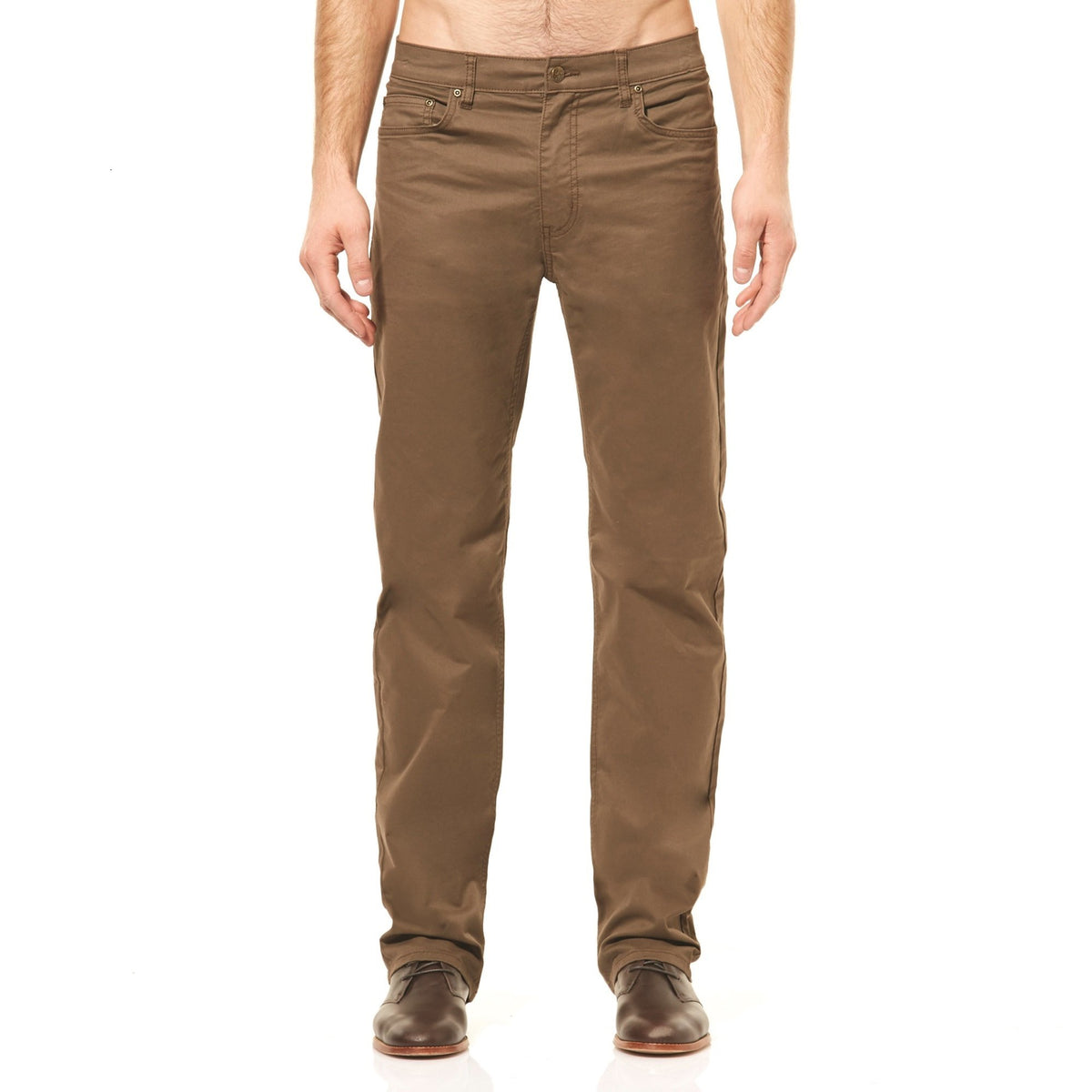 A person stands wearing the stylish Riders Straight Pant Stretch in brown, paired with matching brown shoes. The image is cropped at the waist, leaving the face unseen. The white background accentuates the clothing, making these jean cut pants stand out effortlessly.