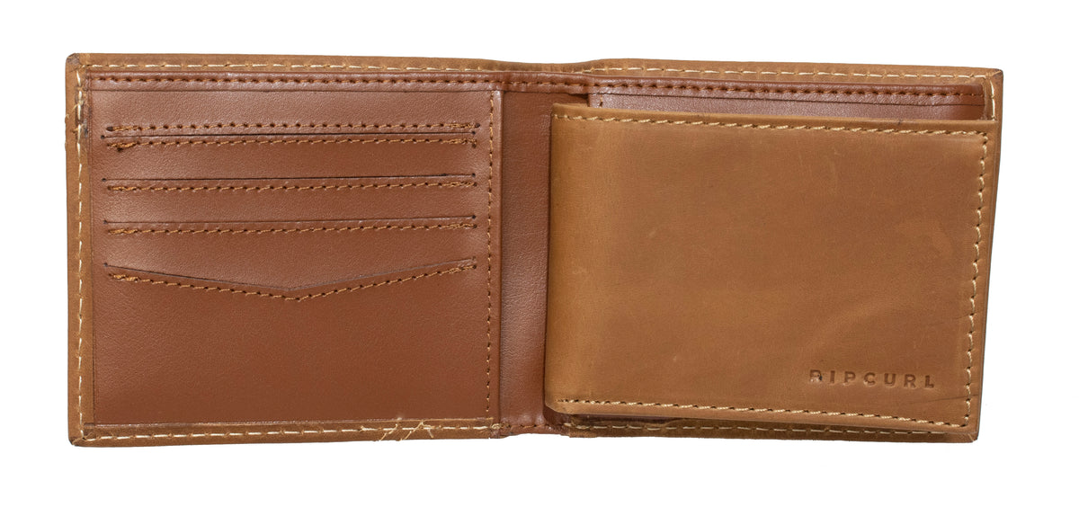 A brown genuine leather Rip Curl A Sport RFID 2 In 1 Wallet is open, revealing its interior. The left side features multiple card slots and a pocket, while the right side has another large pocket. The word "RIPCURL" is embossed on the bottom right corner, ensuring it's both stylish and secure as an RFID wallet.