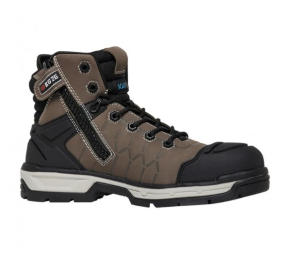 The King Gee Quantum Safety Boot is a rugged, high-top hiking boot with a sturdy black sole and a brown body featuring black and blue accents. This versatile work boot includes metal eyelets for the laces, a side zipper, shock-absorbing protection, and a protective toe cap. The design also features textured surfaces for added durability and grip.