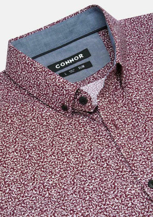 Close-up of the Connor Tate Print Shirt, a maroon and white patterned slim fit made from 100% cotton with a button down collar. The inner label shows "CONNOR" along with size and fit information.
