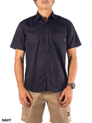 A person wears the UNIT Craftman Stretch Short Sleeve Shirt in navy with two chest pockets and tan cargo shorts, facing forward. "NAVY" is displayed in the bottom left corner.