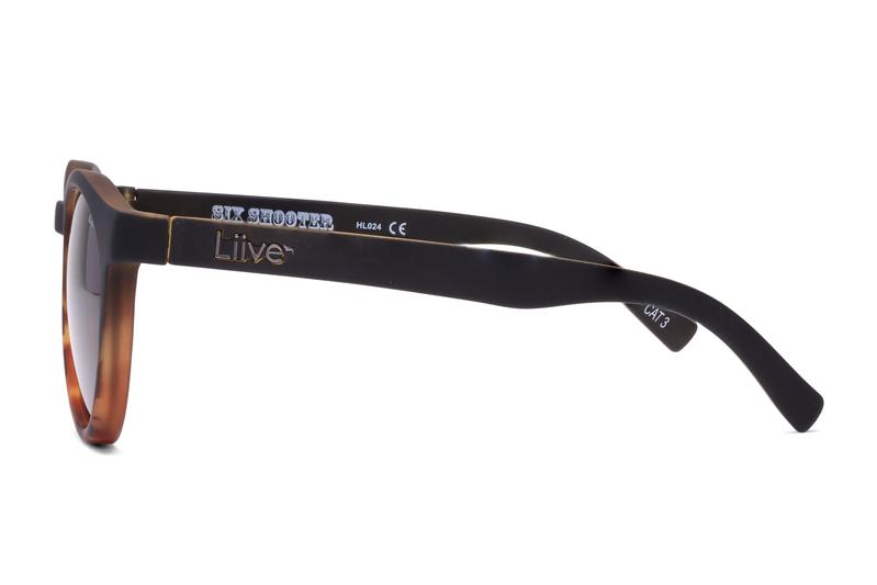 Side view of Liive Six Shooter Sunglasses with black frames and brown UV protection lenses. The sleek, modern design features the "Liive" brand name on the arm and is crafted from lightweight polycarbonate.