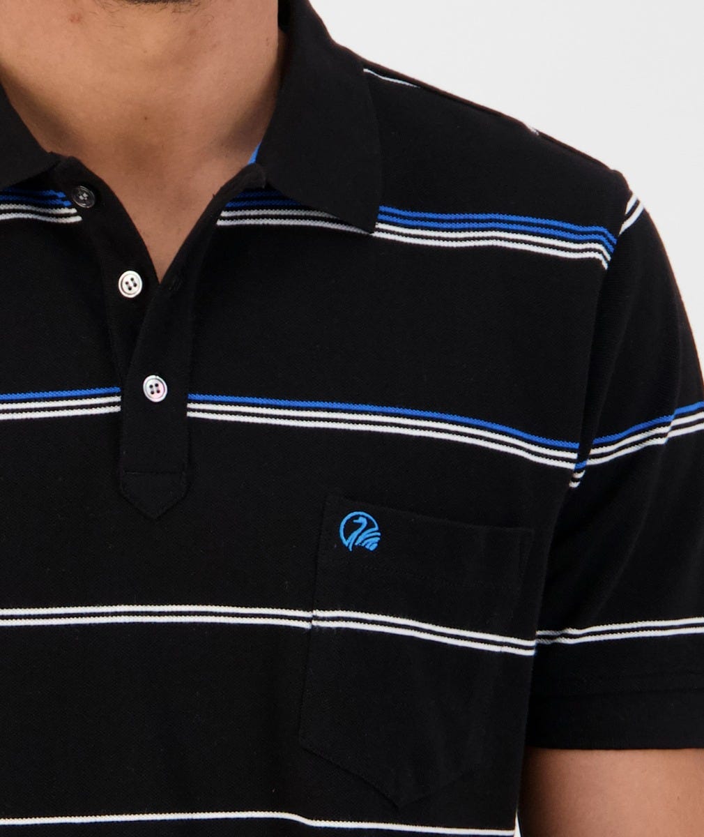 A close-up of a person wearing the Swanndri Concord Stripe Polo, a black casual shirt with blue and white horizontal stripes. Made from 100% cotton, it features a collar, two buttons at the neckline, and a small pocket on the left chest side adorned with a blue embroidered Swanndri logo.