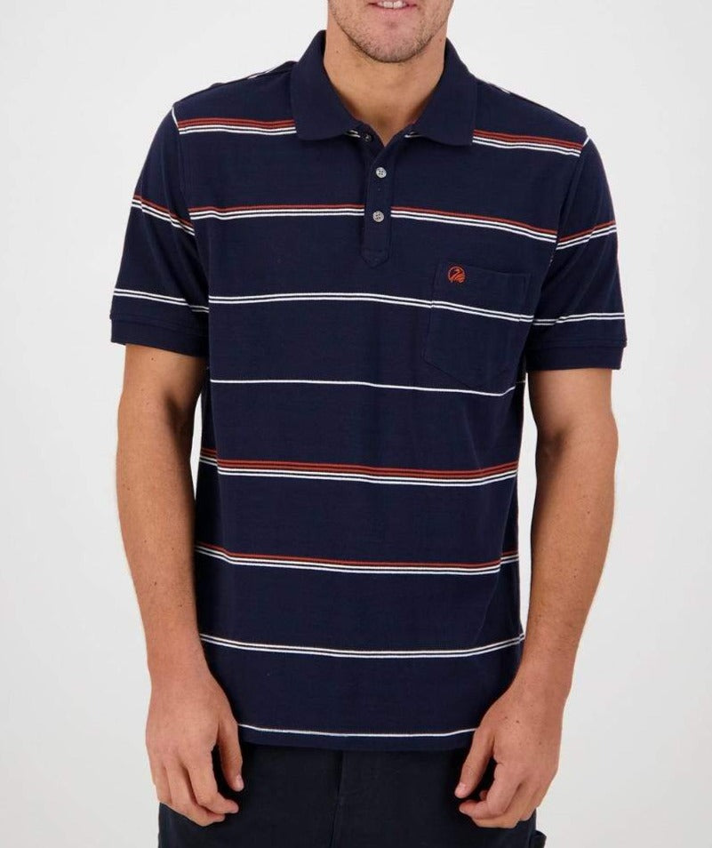 A person wearing the Swanndri Concord Stripe Polo, a navy blue casual shirt adorned with white and red horizontal stripes and featuring the Swanndri logo. The shirt has short sleeves, a small chest pocket, and a buttoned collar. They are standing against a plain white background, with their head not fully visible in the frame.
