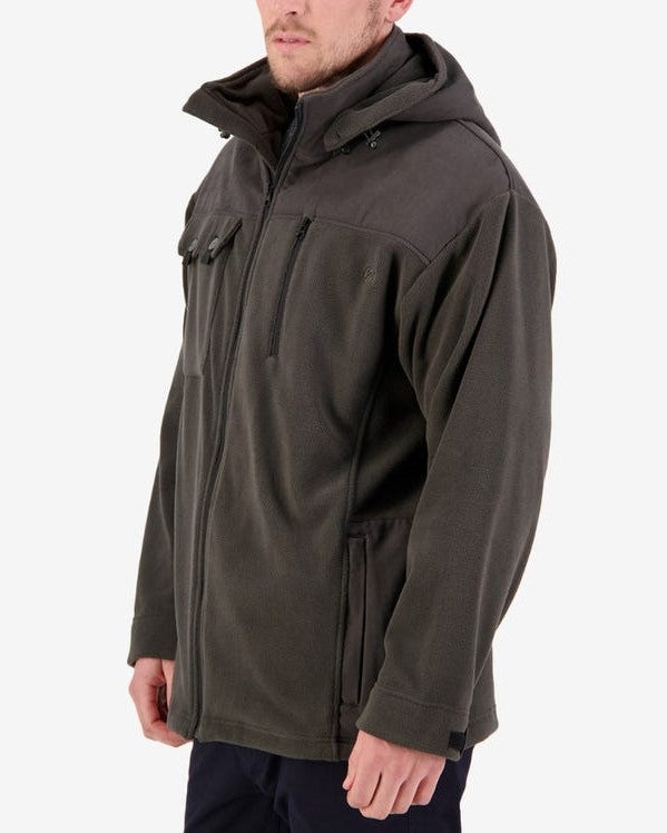 A person wears a Swanndri Low Rock Hoodie, a dark green hooded polyester fleece jacket with a zippered front and high collar. The jacket features multiple pockets, including one on the chest with a flap and two on the sides. The individual stands against a plain white background.