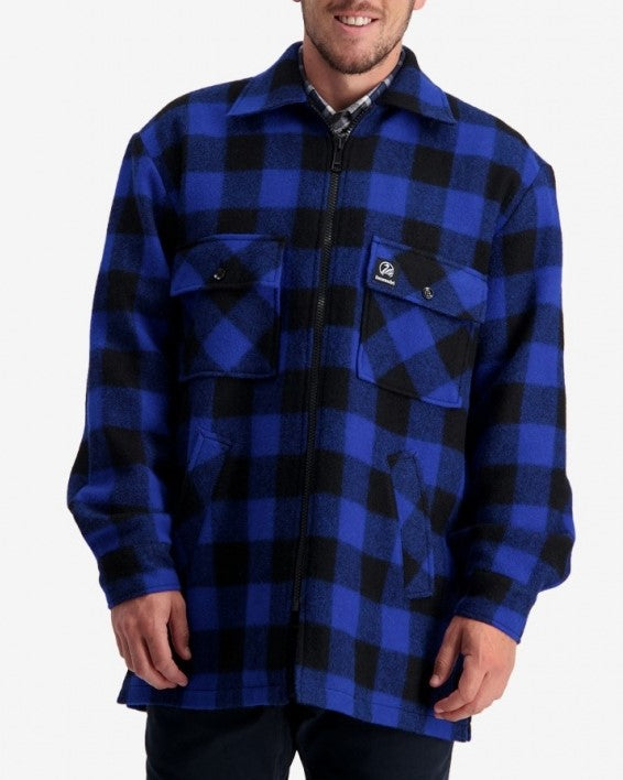 A person is wearing the Swanndri Longford Wool Shacket, which features a blue and black checkered pattern. Made from 100% wool, this versatile shacket includes a zip closure, two chest pockets with flaps, and a small logo on the left chest pocket. It also comes with a lightweight twill lining. The person is standing against a plain white background.