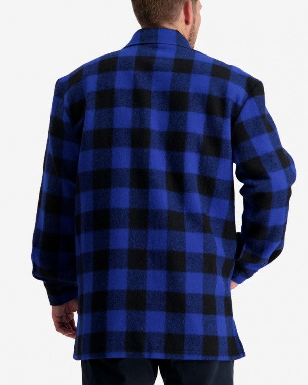 A person seen from behind, wearing a Swanndri Longford Wool Shacket in a blue and black checkered pattern. The shacket, made from 100% wool, features long sleeves and large squares in its classic design. The individual has short hair and is standing against a plain white background.