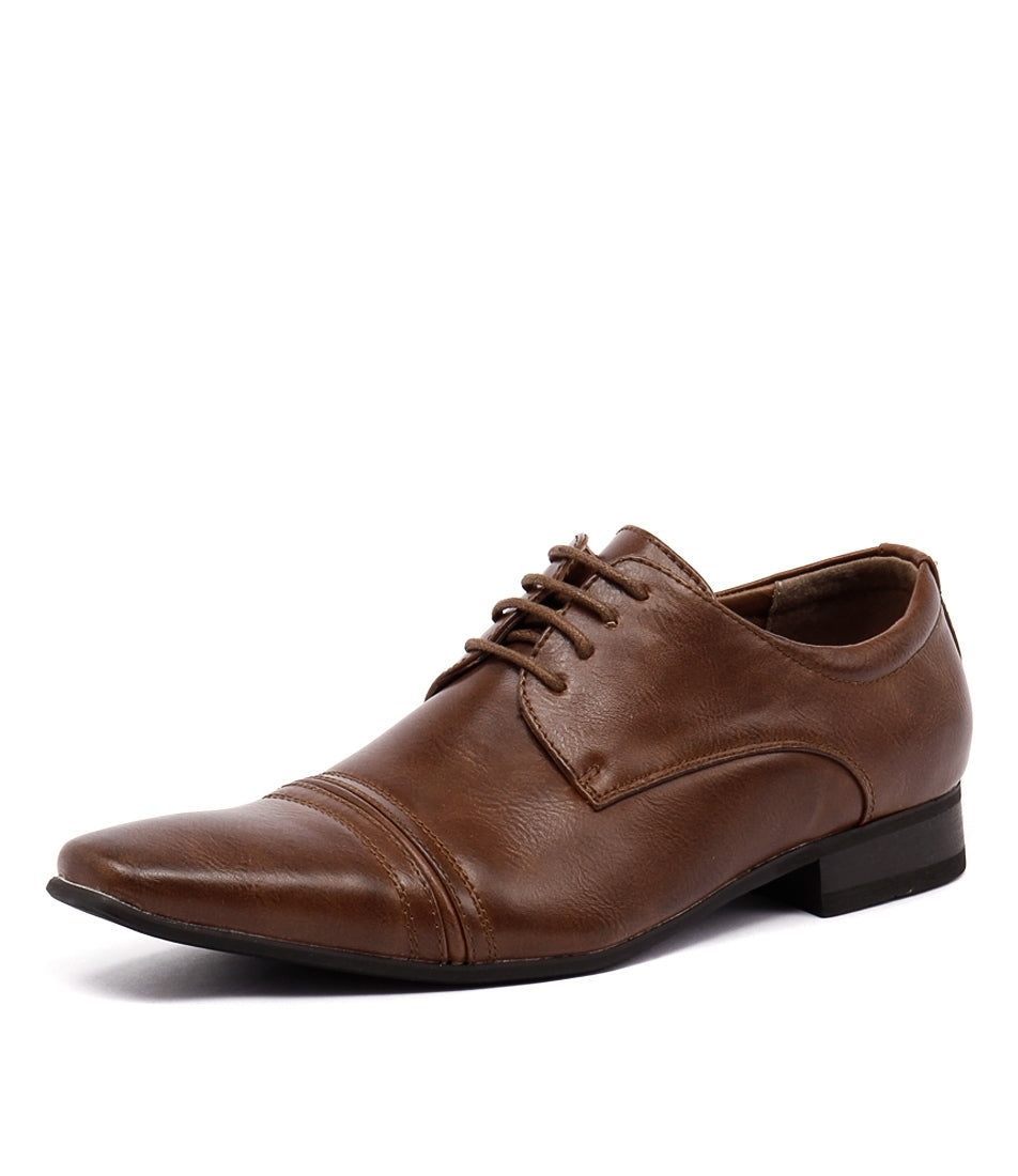 Introducing the UNcut Bartell Shoe: a single brown men's dress shoe that combines elegance and comfort. It features a low heel and lace-up closure, along with a pointed toe highlighted by decorative stitching across the toe cap and sides. The shoe boasts a smooth leather finish, polished to perfection, making it an ideal choice for formal occasions in UK sizing.