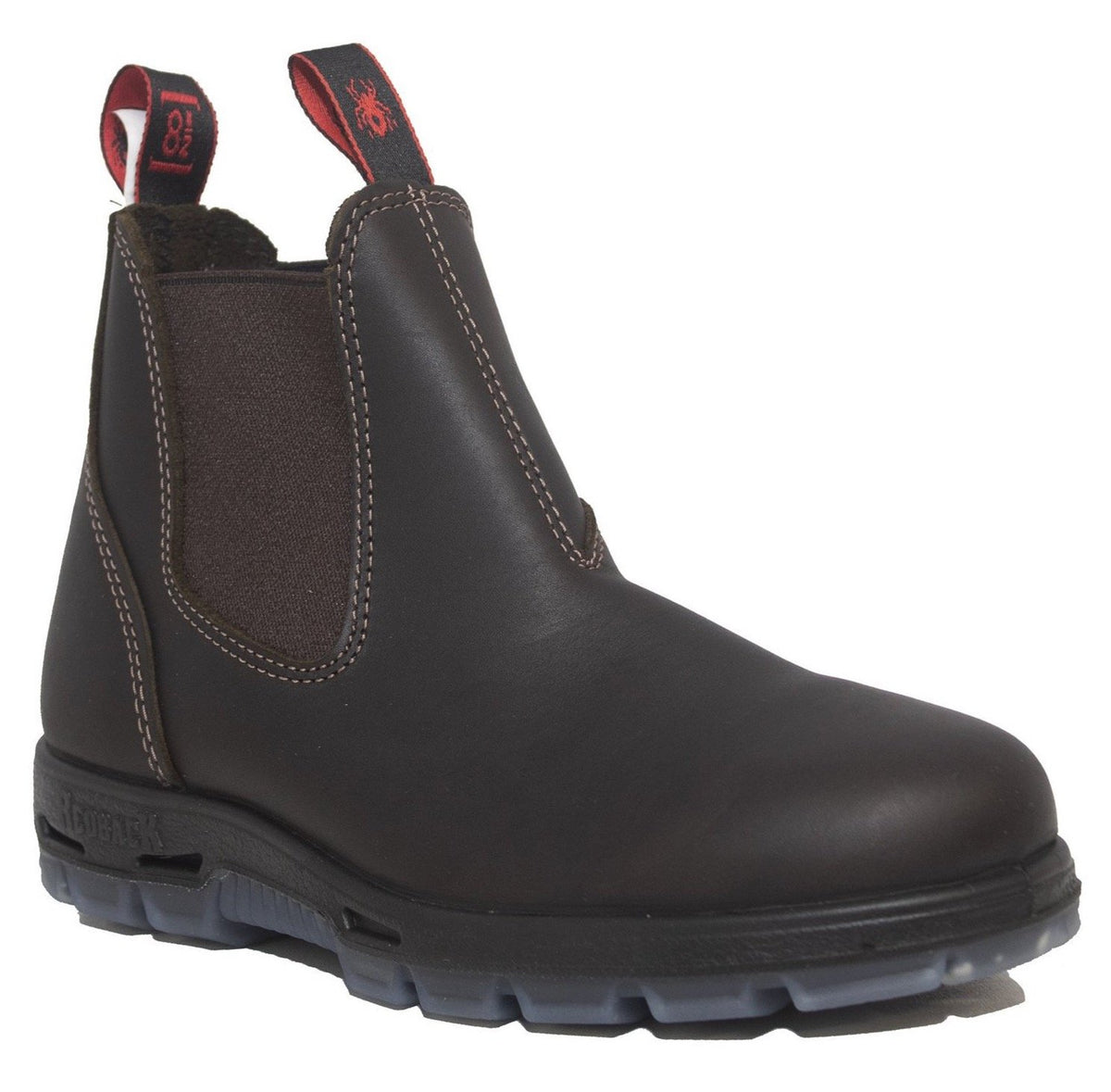 The Redback UNPU Nevada Waterproof Soft Toe is a dark brown leather Chelsea boot with elastic side panels and pull tags. It boasts detailed white stitching, a rugged black sole with visible treads for excellent shock absorption, and red-accented pull tags featuring a small logo—ideal for those in need of a soft toe work boot.