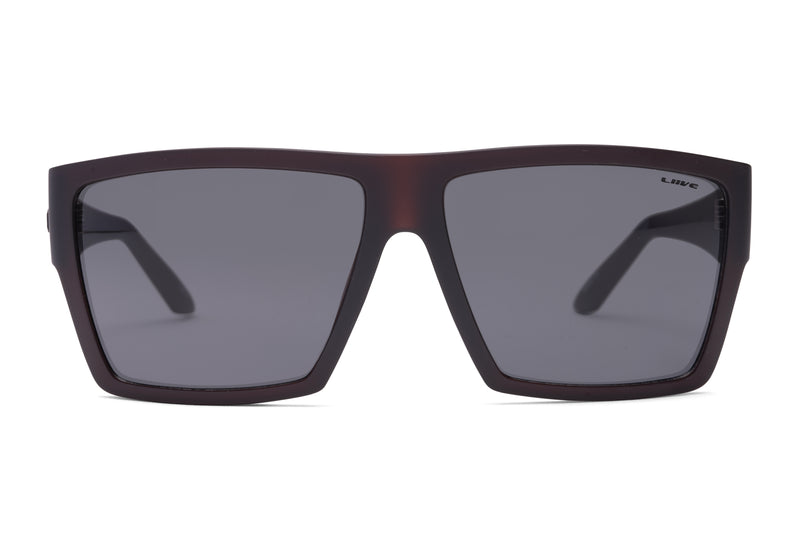 A pair of unisex Liive Volt Sunglasses with a matte black frame and dark rectangular lenses. The design features wide arms and a modern, geometric shape, crafted from lightweight polycarbonate for comfort. The brand name "Liive" is seen on the top corner of one lens, offering stylish UV protection.