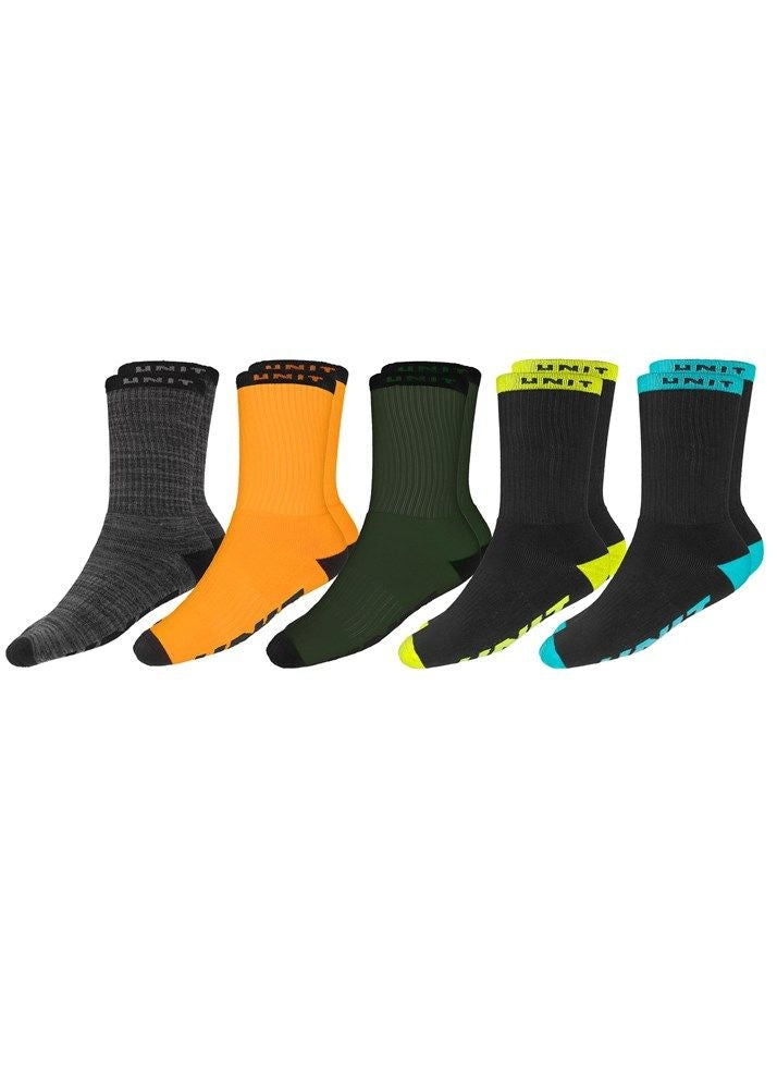 Displayed is the UNIT Quantum 5 Pack Socks, a set of five colorfully assorted crew socks. The set includes pairs in gray, orange, green, black with a neon yellow heel and toe, and black with a teal heel and toe. Each sock features a ribbed texture and a branded top band showcasing the UNIT logo.